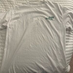 Self care white and green shirt
